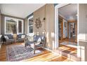 Inviting sunroom with brick accents, ample seating, large windows, and a view into the home at 1419 N Adams St, Denver, CO 80206