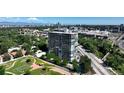 A scenic aerial view shows the building's modern architecture and lush green surroundings with a beautiful park at 3100 E Cherry Creek South Dr # 1507, Denver, CO 80209