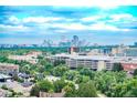 A stunning city view showcasing the skyline from a high vantage point, surrounded by lush greenery and suburban neighborhoods at 3100 E Cherry Creek South Dr # 1507, Denver, CO 80209