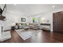 Bright living room with hardwood floors, fireplace, bay window, and stylish furnishings at 8981 E Amherst Dr # E, Denver, CO 80231