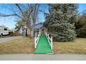 House with a ramp and a green pathway leading to the entrance at 11040 Emerson St, Northglenn, CO 80233