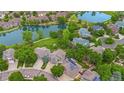 Aerial view of a residential neighborhood with mature trees, community lakes, walking paths, and green spaces at 3237 W 113Th Ave, Westminster, CO 80031