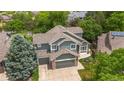Aerial view of a charming two-story home with a three-car garage and mature landscaping at 3237 W 113Th Ave, Westminster, CO 80031