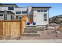 Contemporary home showcases a stylish front entrance, complemented by a well-manicured landscape and eye-catching blue planters at 6353 N Fulton St, Denver, CO 80238