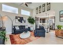 Open-concept living room featuring high ceilings, stylish furnishings, and seamless flow into the adjacent kitchen area at 6353 N Fulton St, Denver, CO 80238