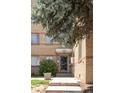 Brick building exterior with a blue door and landscaping at 1101 Bellaire St # 204, Denver, CO 80220