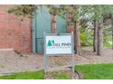 Sign for the Tall Pines community, highlighting its covenant-controlled environment and green landscape at 3518 S Depew St # 102, Lakewood, CO 80235