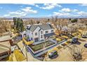 Overhead view of modern two-story home with manicured lawn and mountain view at 4520 W Moncrieff Pl, Denver, CO 80212