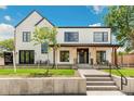 Stylish two-story home boasts modern design and a welcoming front porch with seating at 4520 W Moncrieff Pl, Denver, CO 80212