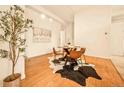 Well lit dining area with wood floors, a round table with seating for four, and bright white walls at 1140 Columbine St # 106, Denver, CO 80206
