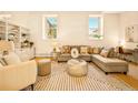 Bright and airy living room featuring built-in shelving, a comfortable sectional, and large windows at 1140 Columbine St # 106, Denver, CO 80206