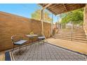 Inviting private outdoor patio with seating, textured rug and a view of the exterior stairs at 1140 Columbine St # 106, Denver, CO 80206