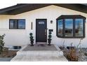 Elegant entrance featuring a stylish front door, bay window, and brick accents at 3400 S Ivy Way, Denver, CO 80222