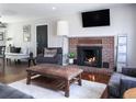 Relaxing living room with a brick fireplace, hardwood floors, and natural light at 3400 S Ivy Way, Denver, CO 80222