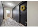 Interior hallway featuring unit door with wreath and access to staircase at 75 N Emerson St # 104, Denver, CO 80218