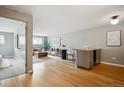 Open floor plan with hardwood floors with view into the living room and dining area at 75 N Emerson St # 104, Denver, CO 80218