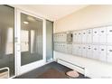 Condo lobby entrance with mailboxes and glass doors allowing natural light at 75 N Emerson St # 104, Denver, CO 80218