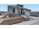 Attractive two-story home with modern siding, stone accents, a covered porch and an attached garage at 1871 Grayside Cir, Castle Rock, CO 80109