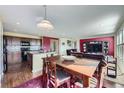 An open-concept kitchen and dining area flow seamlessly into the living room, perfect for modern living and entertaining at 5280 Raritan Way, Denver, CO 80221