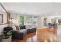 Inviting living room featuring hardwood floors, large windows with bright, natural light and cozy furnishings at 9066 Apache Plume Dr # E, Parker, CO 80134