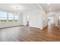 Open living room with wood-look floors and lots of natural light at 8601 Yellowcress St, Littleton, CO 80125