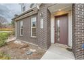 Close-up of the front entrance showcasing the brick exterior, the house number, and stylish front door at 5107 S Fairplay St, Aurora, CO 80015