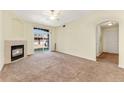 Living room with a fireplace and sliding glass doors leading to a patio at 7440 S Blackhawk St # 2-104, Englewood, CO 80112