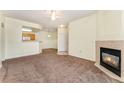 Bright open living room with a fireplace, dining area and view into the kitchen at 7440 S Blackhawk St # 2-104, Englewood, CO 80112