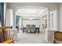 Dining area featuring white columns, gray chairs and a modern chandelier at 2810 Shadow Dance Dr, Castle Rock, CO 80109