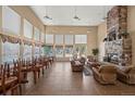 Spacious community room with a stone fireplace, large windows overlooking pool, and seating at 5255 Memphis St # 811, Denver, CO 80239