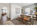 Modern home office featuring stylish decor, wood floors, and ample workspace at 27664 E Byers Ave, Aurora, CO 80018