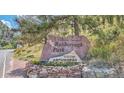 Roxborough Park community sign featuring stacked stone and surrounding greenery at 7357 S Yank Ct, Littleton, CO 80123