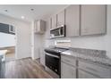 Modern kitchen with stainless steel appliances, grey cabinets and granite countertops at 22103 E 38Th Pl, Aurora, CO 80019