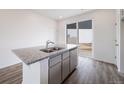 Kitchen island featuring stainless steel dishwasher and a granite countertop at 22103 E 38Th Pl, Aurora, CO 80019