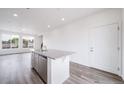 Kitchen island featuring stainless steel dishwasher and a granite countertop at 22103 E 38Th Pl, Aurora, CO 80019