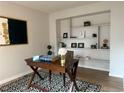 Bright office space featuring a wooden desk and stylish built-in shelving at 11753 Pennsylvania St, Northglenn, CO 80233