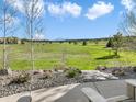 Backyard view with chairs, rock garden, and beautiful views of the surrounding landscape at 1236 Castlecombe Ln, Monument, CO 80132
