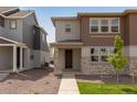Inviting two-story home with a mix of stone and siding, complemented by a neat walkway and fresh landscaping at 1415 Great Western Dr, Longmont, CO 80501