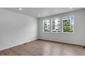 Bright living room with wood floors, recessed lighting, and large windows offering a view of the outdoors at 1415 Great Western Dr, Longmont, CO 80501