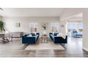 Well-lit living room with hardwood floors, stylish seating arrangements, and modern decor at 6749 Shannon Trl, Highlands Ranch, CO 80130