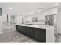 Spacious kitchen features a large island with modern fixtures, stainless steel appliances, and plenty of cabinets at 217 Douglas Fir Ave, Castle Rock, CO 80104