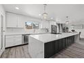 Bright, newly renovated kitchen with a large island, stainless steel appliances, and modern lighting at 217 Douglas Fir Ave, Castle Rock, CO 80104