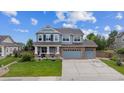 Beautiful two-story home featuring a well-manicured front lawn and an attached three-car garage at 7083 Winthrop Cir, Castle Rock, CO 80104