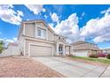 Attractive two-story home with a two-car garage and concrete driveway under a partly cloudy sky at 21354 E 51St Ave, Denver, CO 80249