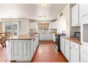 Spacious white kitchen with an island, plenty of cabinet space, and stainless steel appliances at 21354 E 51St Ave, Denver, CO 80249