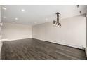 Spacious living room with hardwood floors, recessed lighting, and a stylish industrial chandelier at 955 Eudora St # 207E, Denver, CO 80220