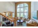 Bright living room with a soaring window, comfortable seating, and views to the adjacent dining area at 10859 Irving Ct, Westminster, CO 80031