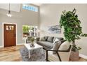 Bright living room with tall ceilings, neutral colors, and modern furnishings for a comfortable space at 9885 Thornbury Way, Highlands Ranch, CO 80129