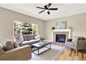 Comfortable living room features a fireplace, large windows, and stylish decor for a relaxing atmosphere at 9885 Thornbury Way, Highlands Ranch, CO 80129