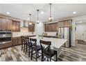 Spacious kitchen with a large center island, stainless steel appliances, and modern lighting at 6616 Amur Ln, Castle Rock, CO 80108